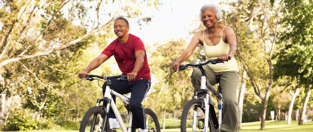 Senior Couple Riding Bikes In Park