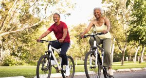 Senior Couple Riding Bikes In Park